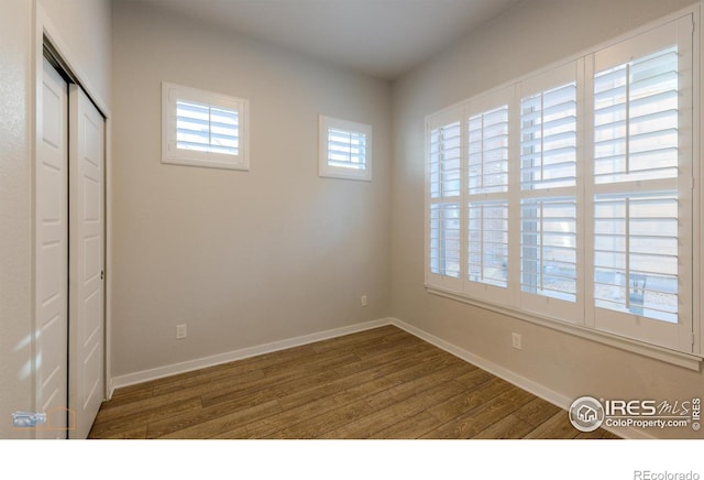 empty room with hardwood / wood-style floors