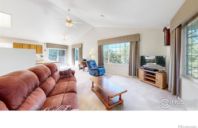 carpeted living room featuring a healthy amount of sunlight and vaulted ceiling