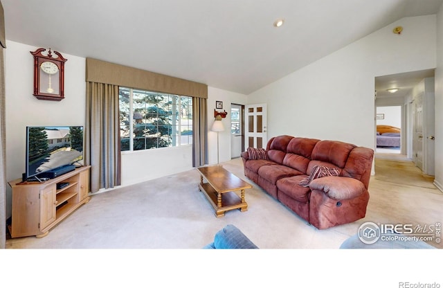 living room with lofted ceiling and light carpet