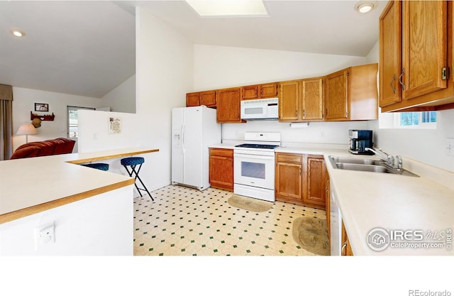 kitchen with plenty of natural light, white appliances, sink, and high vaulted ceiling