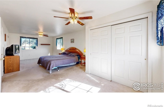 carpeted bedroom with a closet and ceiling fan