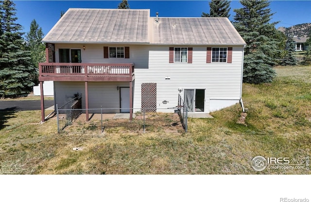 back of property featuring a wooden deck