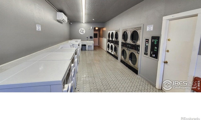 laundry room with separate washer and dryer, stacked washer and clothes dryer, and a wall unit AC