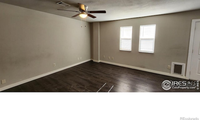 spare room with dark hardwood / wood-style floors and ceiling fan