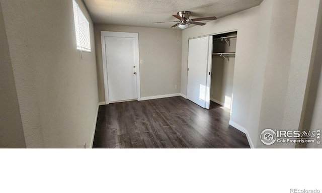 unfurnished bedroom with dark hardwood / wood-style flooring, a closet, and ceiling fan