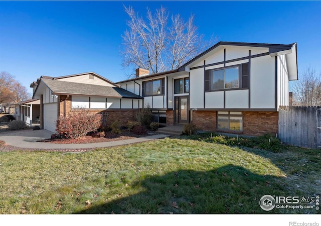 view of front of property with a garage and a front lawn