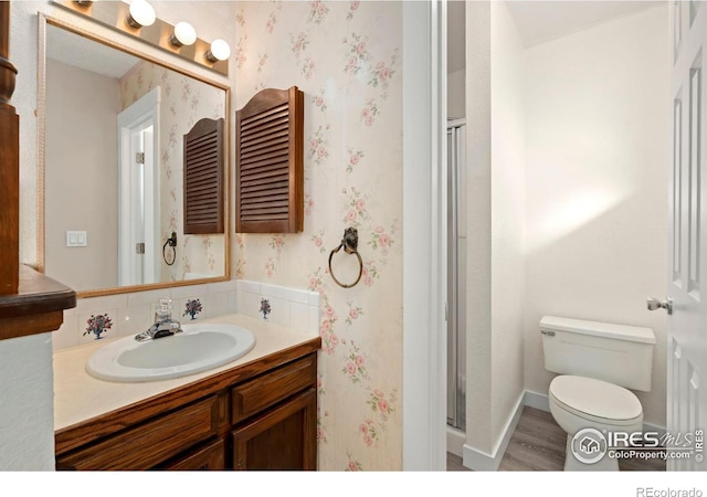 bathroom featuring hardwood / wood-style flooring, vanity, and toilet