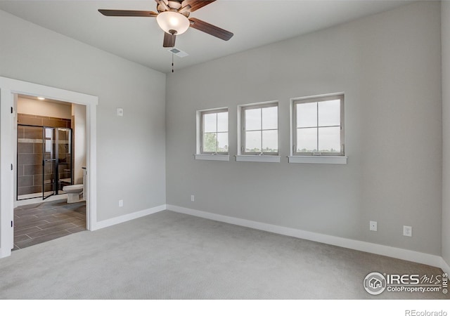 unfurnished room with carpet flooring and ceiling fan