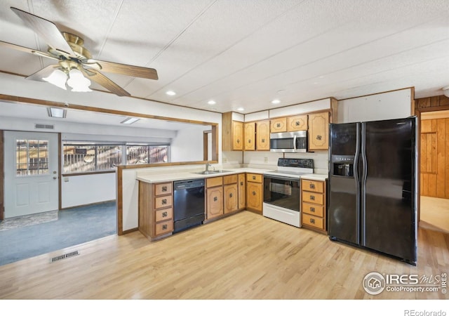 kitchen featuring black appliances, ceiling fan, a textured ceiling, and light hardwood / wood-style flooring