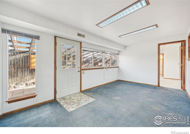 interior space with carpet flooring and plenty of natural light