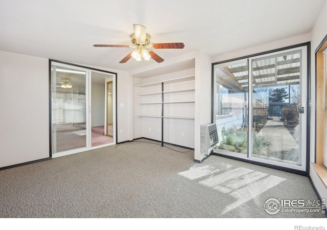 carpeted empty room featuring ceiling fan