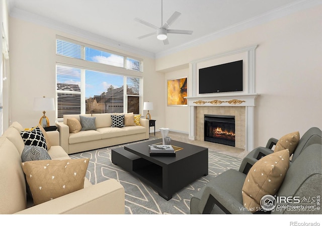 living room featuring a fireplace, ornamental molding, and ceiling fan