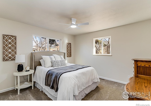 bedroom with ceiling fan, baseboards, and dark colored carpet