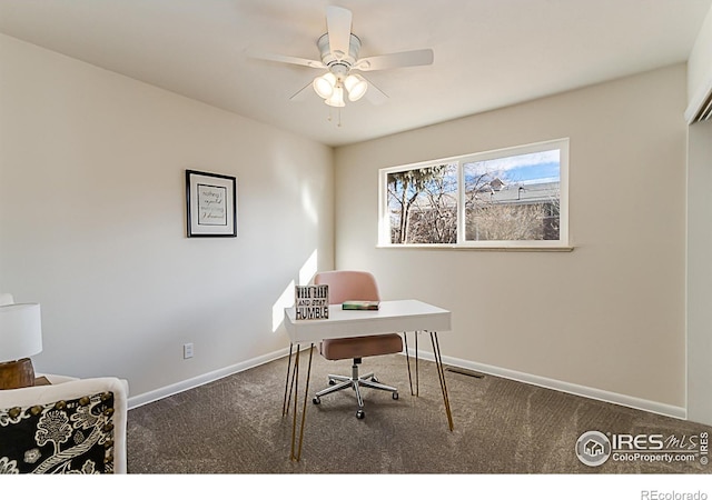 carpeted office space featuring ceiling fan, visible vents, and baseboards