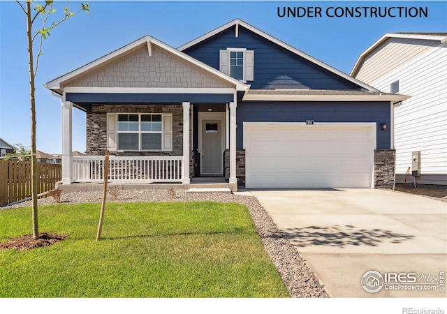 craftsman-style home featuring a porch, a garage, and a front yard