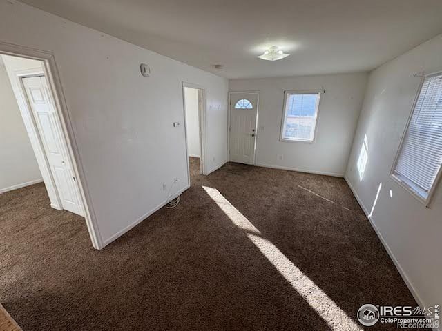 interior space featuring dark carpet
