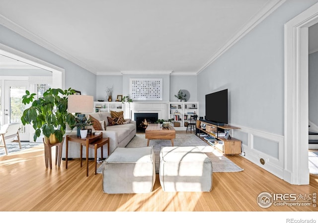 living room featuring crown molding and hardwood / wood-style floors