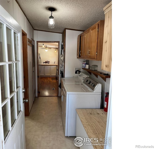 laundry area with washer and clothes dryer, cabinets, ceiling fan, a textured ceiling, and light hardwood / wood-style floors