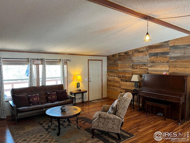 living room with crown molding, wooden walls, vaulted ceiling, dark hardwood / wood-style floors, and a textured ceiling