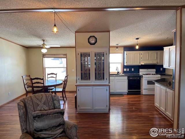 kitchen with white range with gas stovetop, a textured ceiling, black dishwasher, and white cabinets