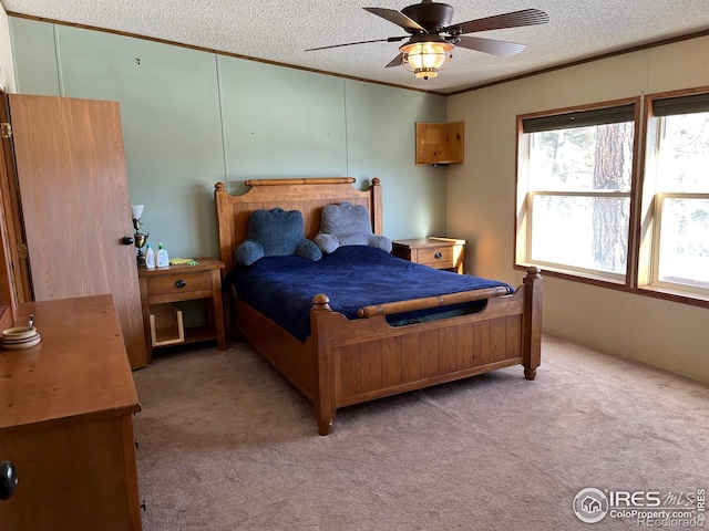 carpeted bedroom with ceiling fan and a textured ceiling