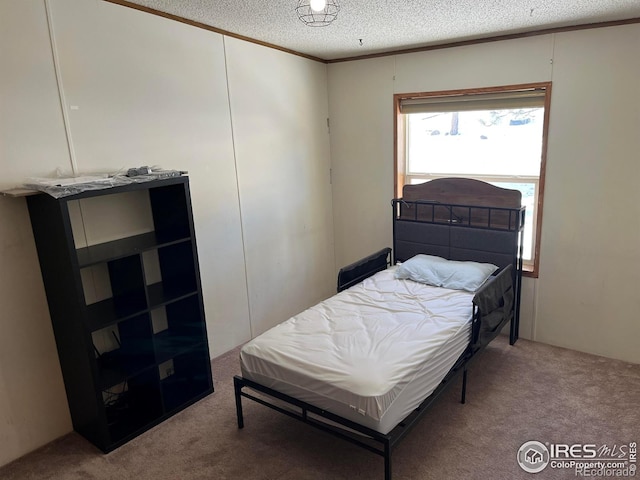 carpeted bedroom featuring crown molding and a textured ceiling