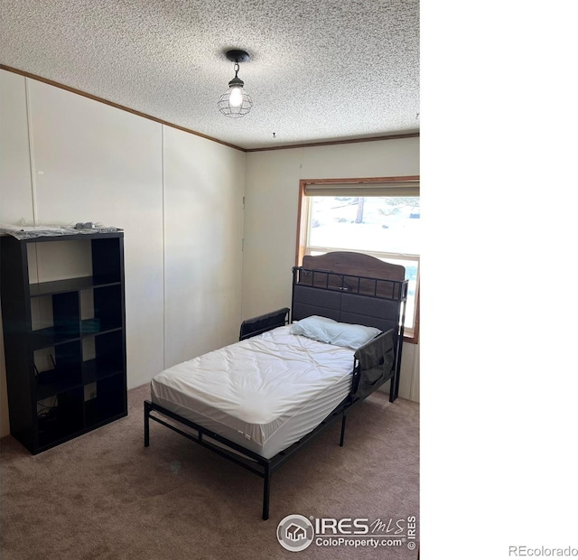 carpeted bedroom featuring a textured ceiling and crown molding