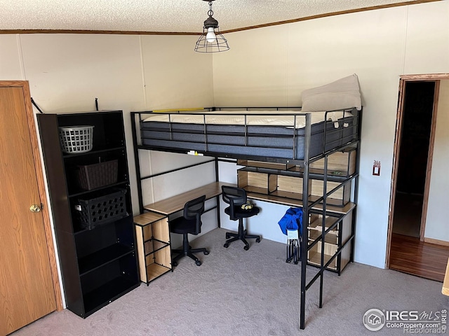 carpeted bedroom with ornamental molding, a textured ceiling, and lofted ceiling