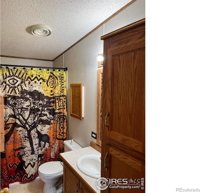 bathroom featuring vanity, a shower with curtain, crown molding, toilet, and a textured ceiling