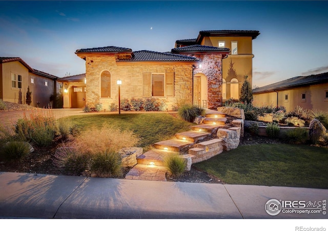 mediterranean / spanish-style house featuring a yard