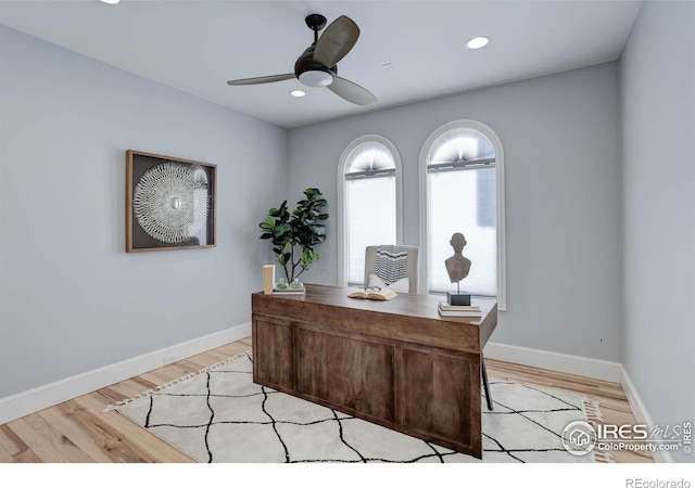 office space featuring ceiling fan and light wood-type flooring