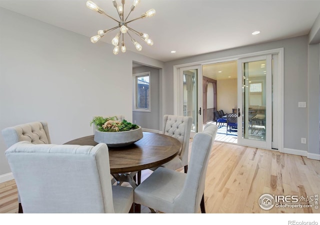 dining room with a chandelier and light hardwood / wood-style flooring