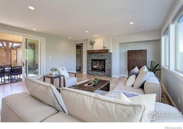 living room featuring a fireplace and light hardwood / wood-style flooring