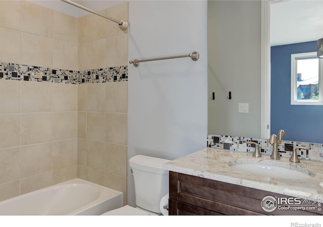 full bathroom featuring vanity, toilet, and tiled shower / bath