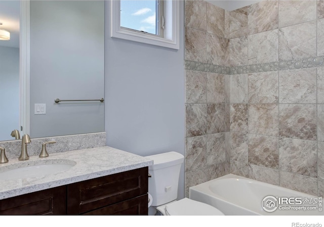 full bathroom with vanity, toilet, and tiled shower / bath