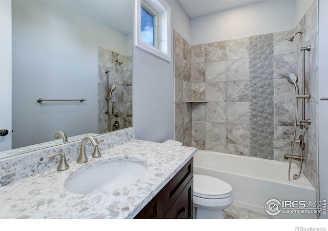 full bathroom with tile patterned flooring, vanity, toilet, and tiled shower / bath