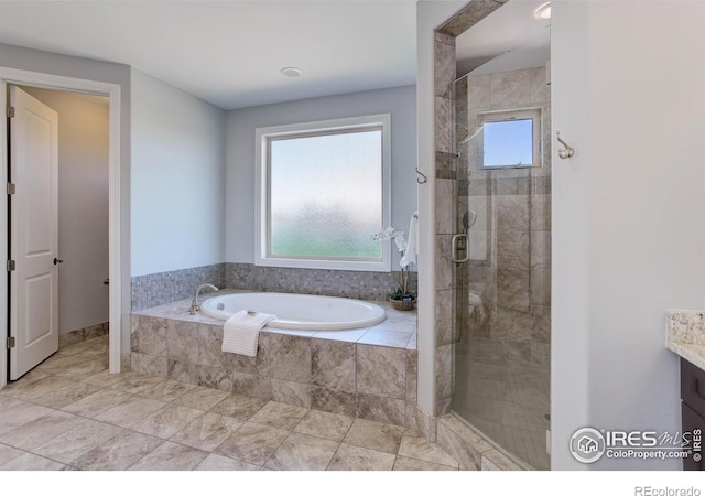 bathroom featuring separate shower and tub, a wealth of natural light, and vanity