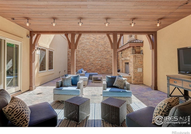 view of patio / terrace with an outdoor living space with a fireplace