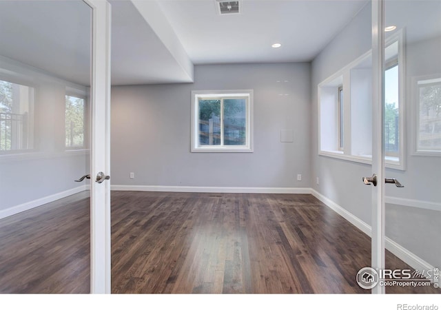 spare room with french doors and dark wood-type flooring