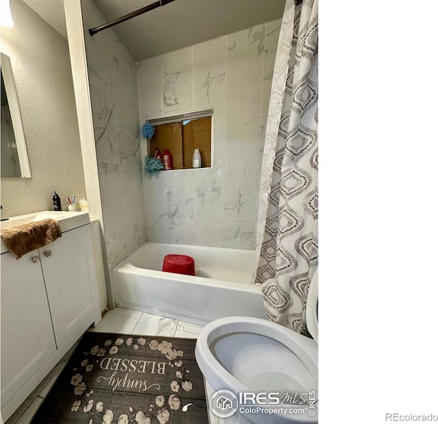 bathroom featuring tile patterned flooring, vanity, and shower / bath combo with shower curtain