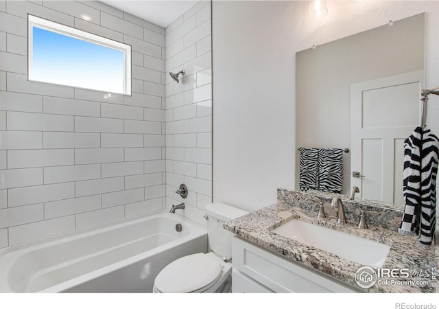 full bathroom with vanity, tiled shower / bath combo, and toilet