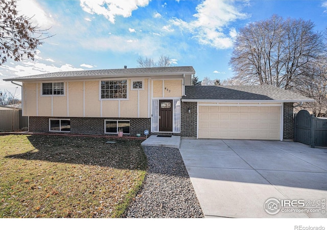 split foyer home with a front lawn and a garage