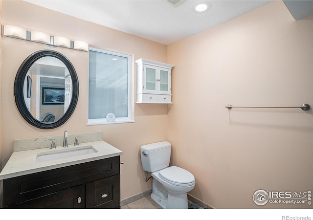 bathroom featuring vanity and toilet