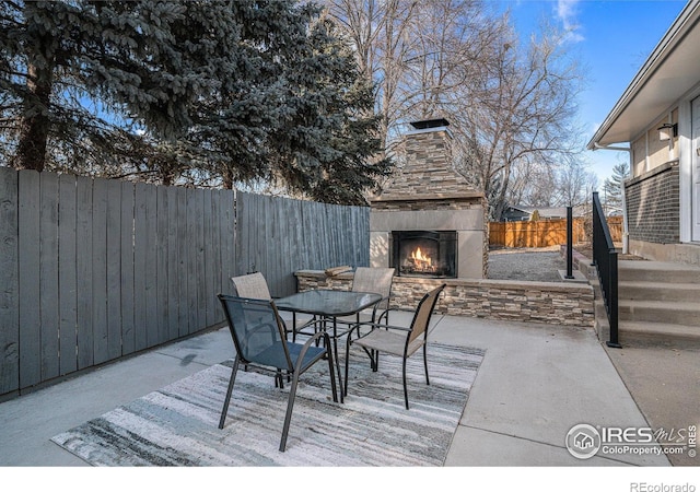 view of patio featuring an outdoor stone fireplace