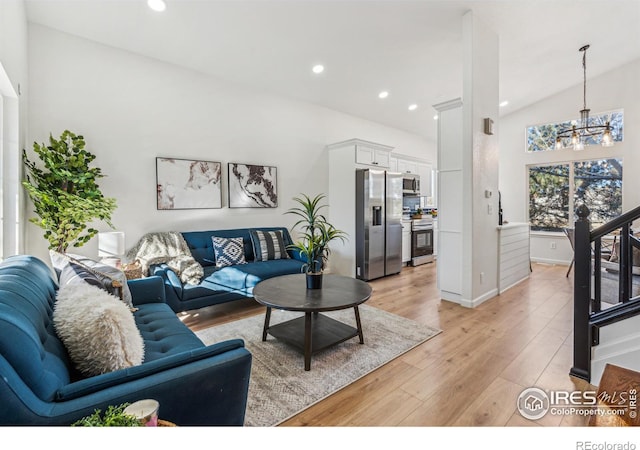 living area featuring a chandelier, high vaulted ceiling, light wood-type flooring, and recessed lighting