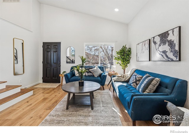 living room featuring high vaulted ceiling, recessed lighting, wood finished floors, visible vents, and baseboards