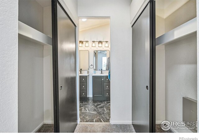 bathroom with vanity and baseboards