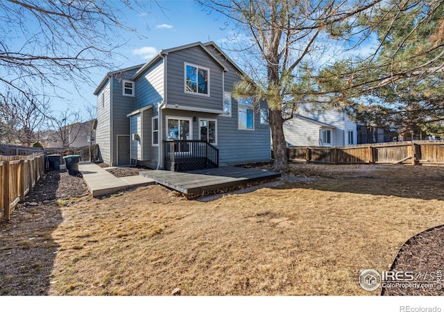 back of property with a yard and a fenced backyard