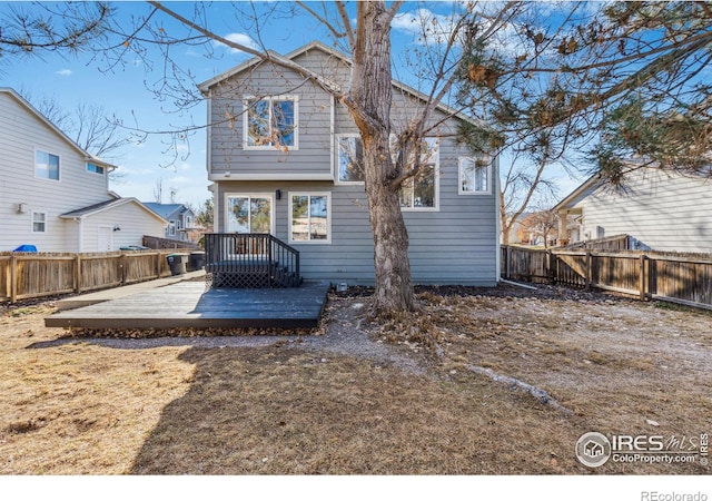 back of property featuring a fenced backyard and a wooden deck