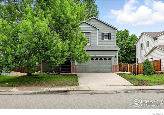608 Bluegrass Dr, Longmont, CO 80503 - traditional-style house featuring concrete driveway, brick siding, and a garage